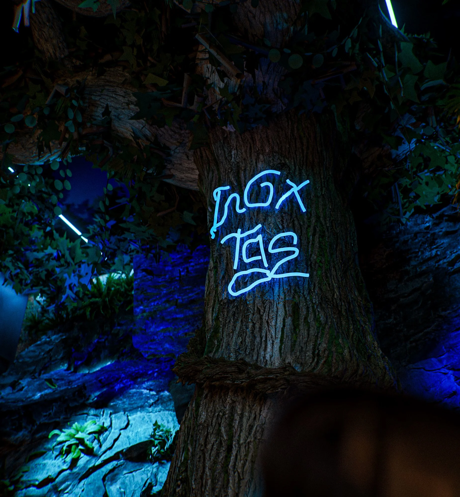 Close-up of the blue neon Inoxtag signature traced on a tree trunk