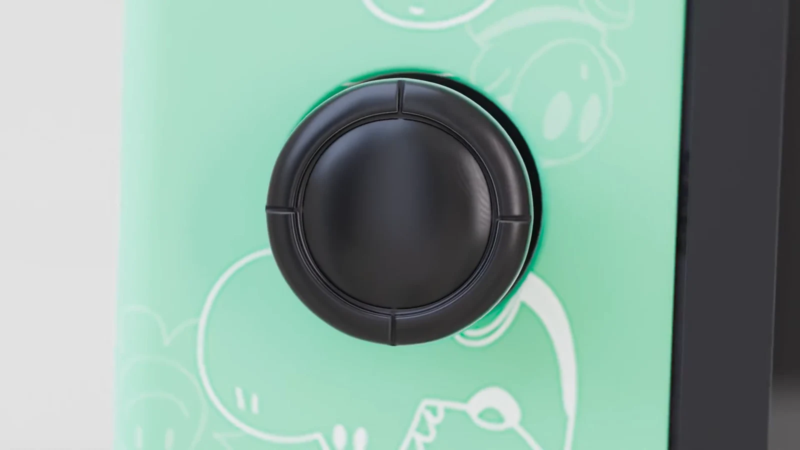 Détail du joystick sur le Joy-Con vert de la Nintendo Switch.