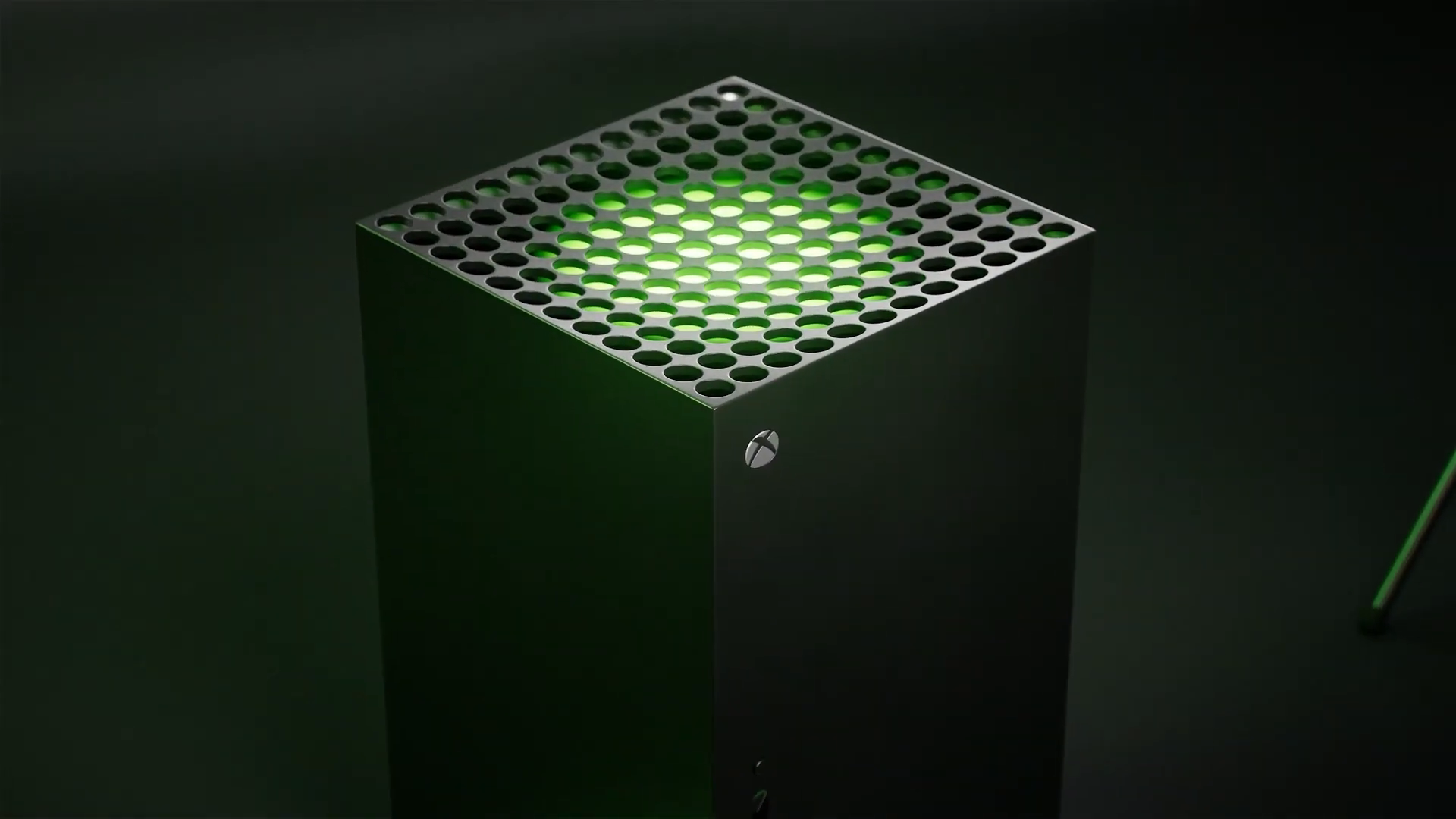 Vue de trois quarts de la Xbox Series X et de sa grille éclairée de vert.